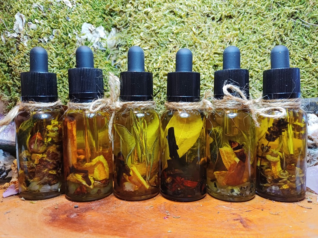 Ritual spell oils for witchcraft. Dropper bottles infused with herbs and crystals for spells.