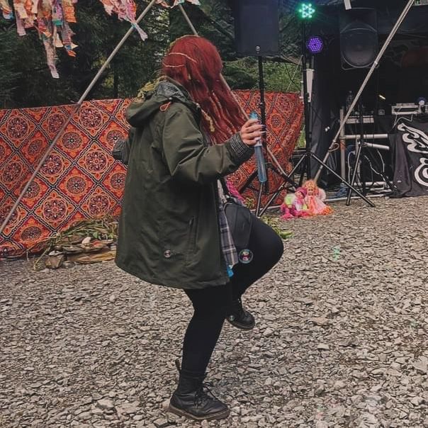 A red-haired woman dances alone